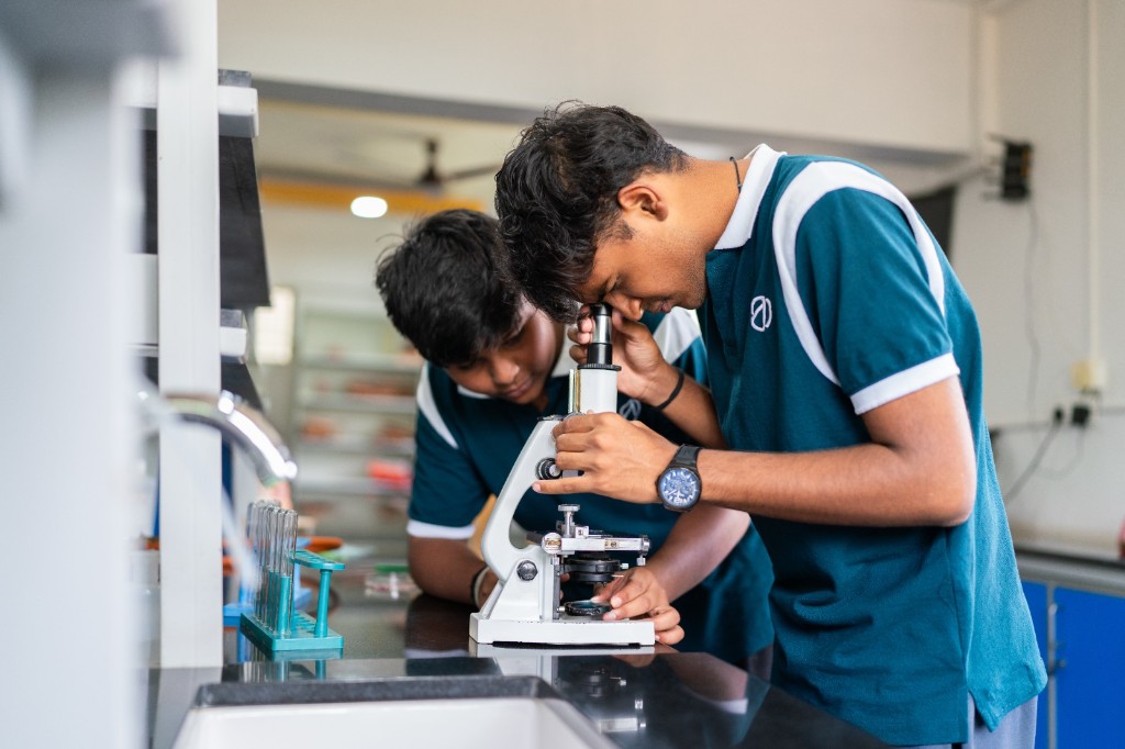 Students examining a specimen under a microscope
