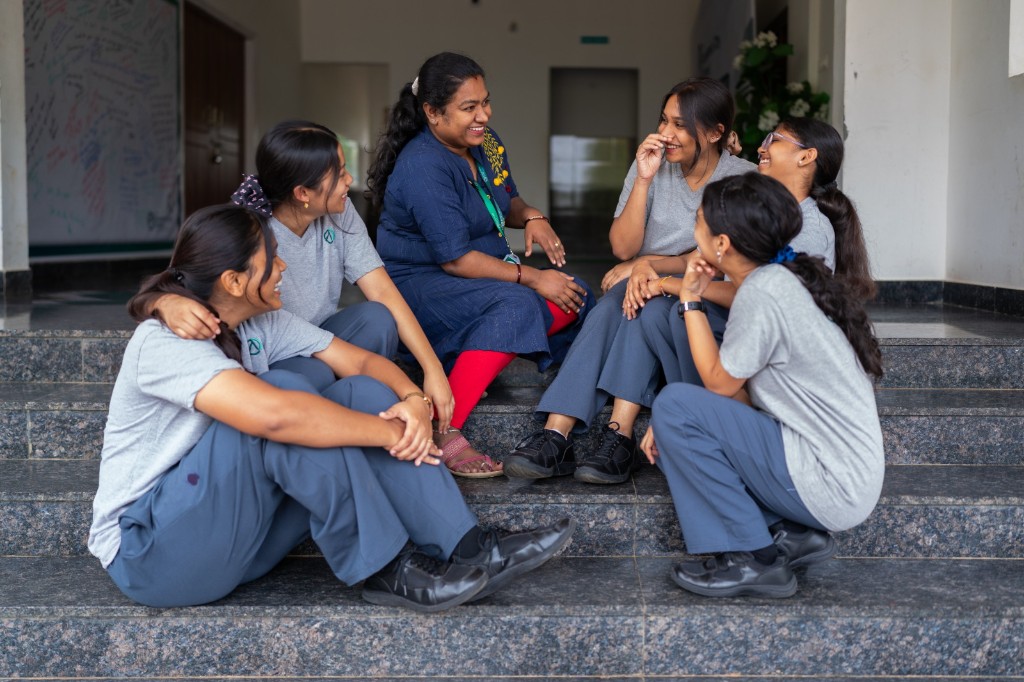 Dorm parent with students at TACS
