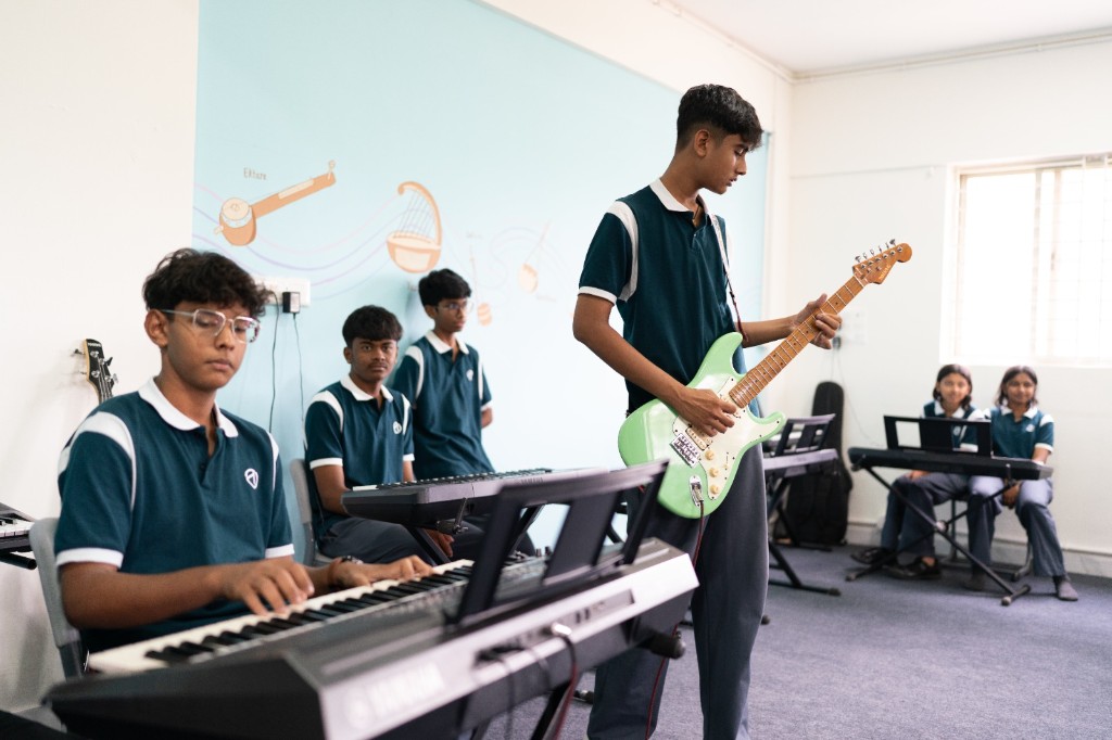 Students practising music in the performing arts room at TACS