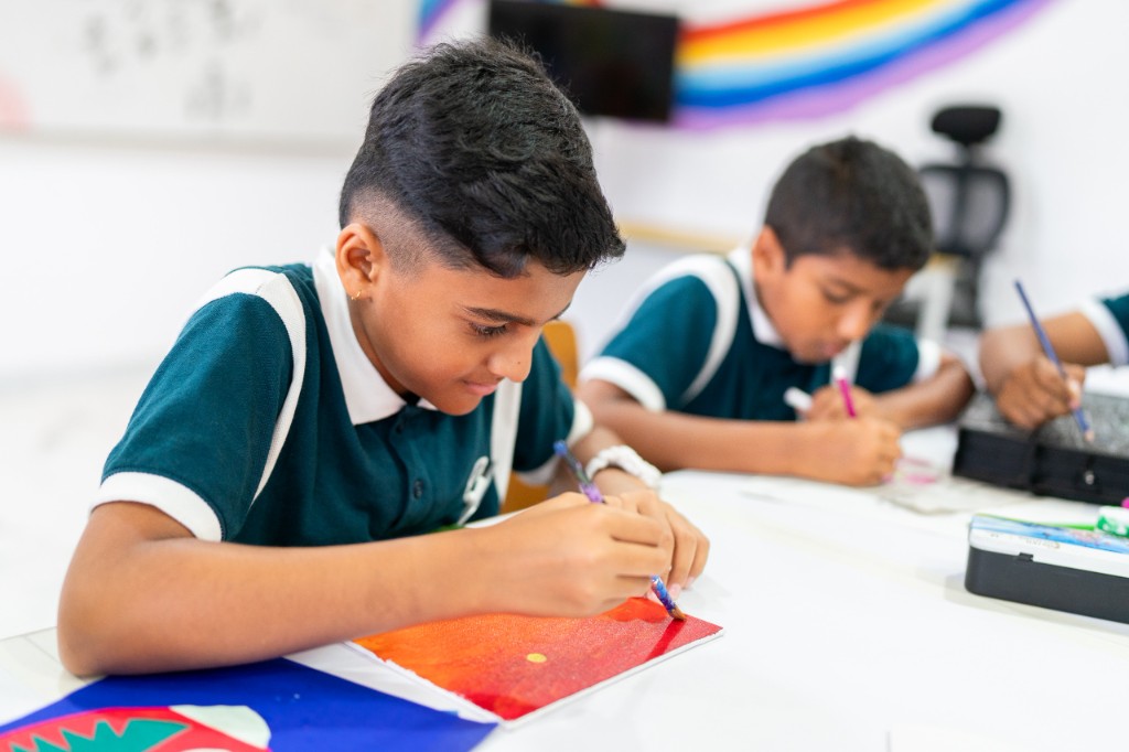 Student painting during an art class at TACS
