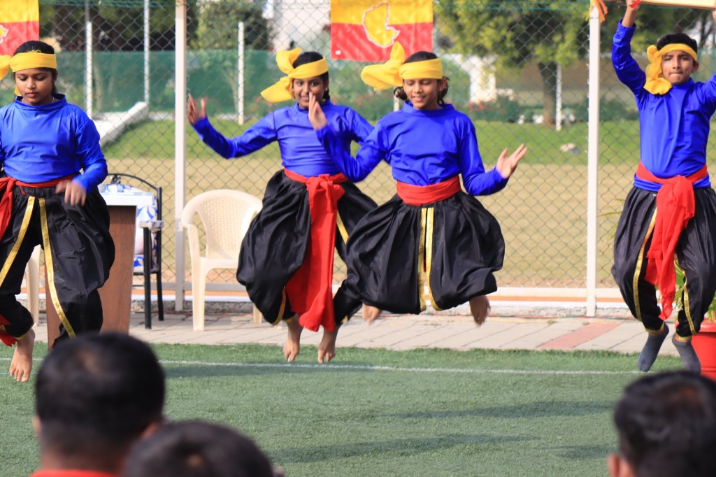 Students performing a traditional folk dance at TACS