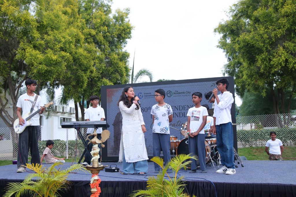 Students performing music on stage during Independence Day celebrations at TACS