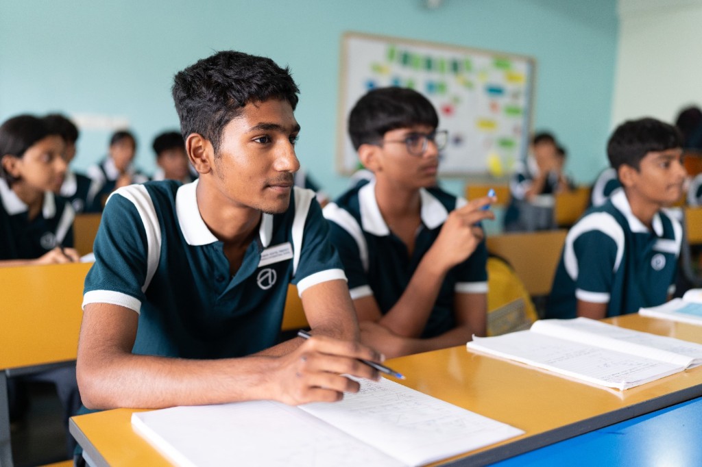 Student focused on learning in the classroom at TACS
