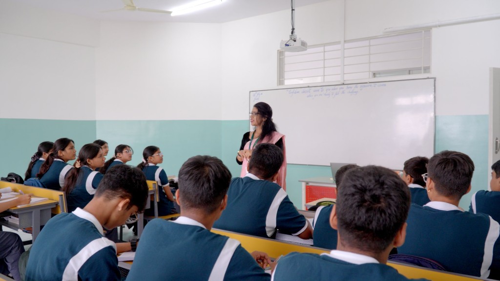 Teacher leading an interactive classroom session at TACS