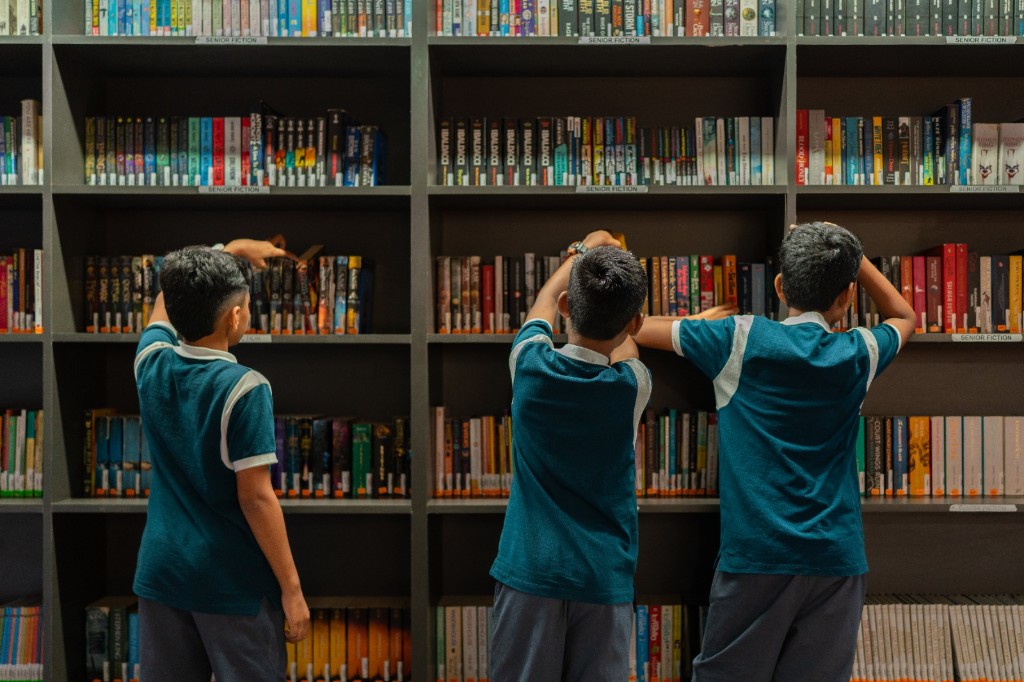 Students browsing books in the TACS library