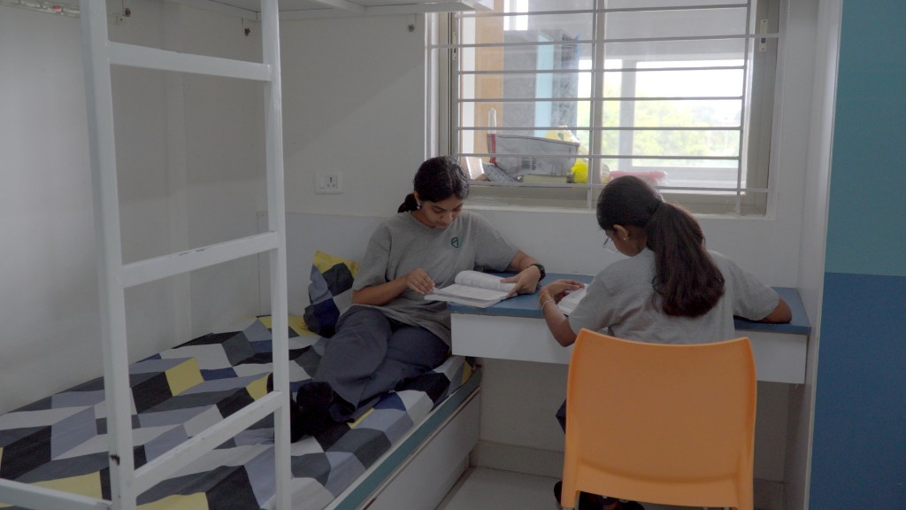 Students studying together in a hostel room at TACS