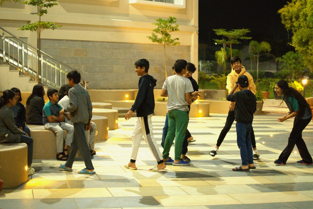 Students spending time together on campus in the evening at TACS
