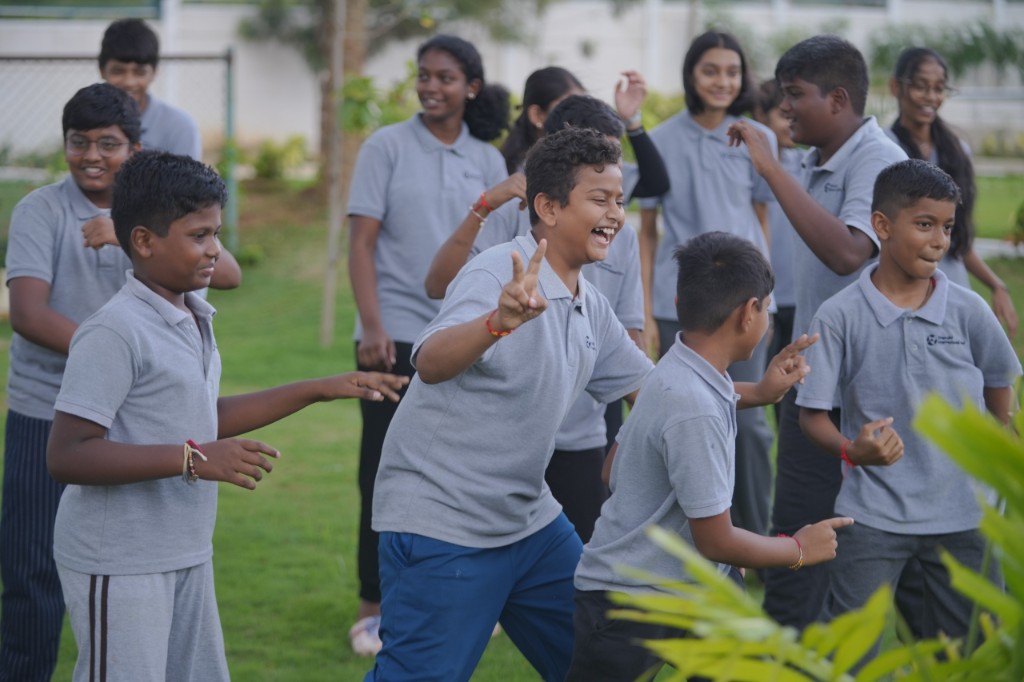 Students enjoying outdoor activities on campus at TACS
