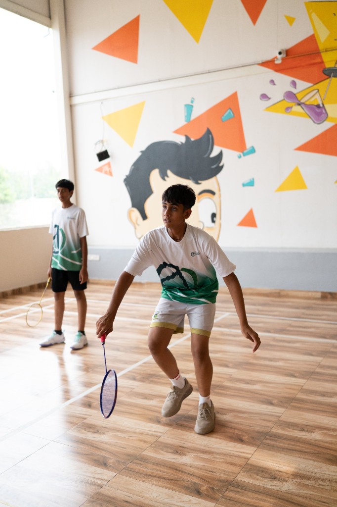 Students playing badminton on campus at TACS