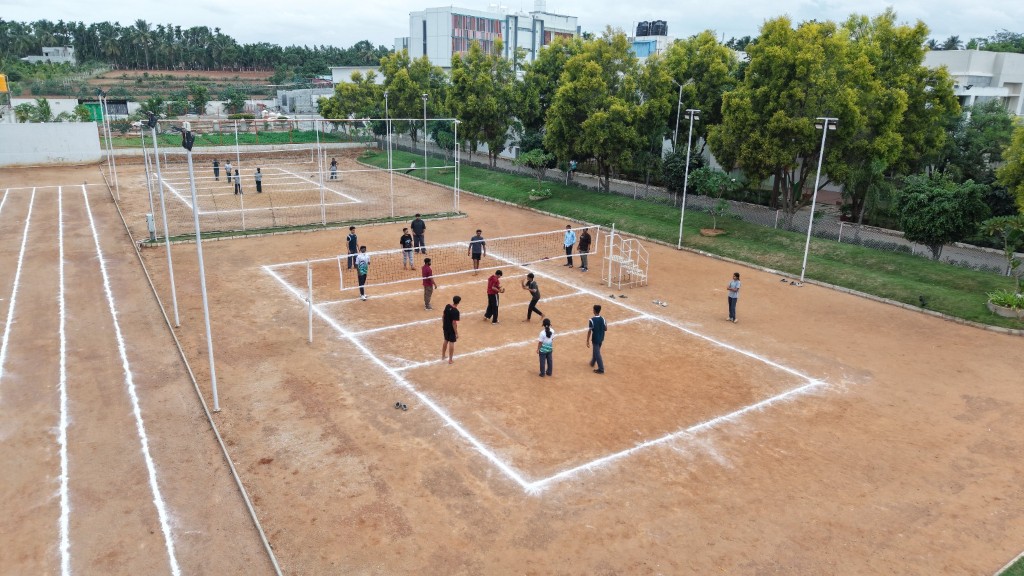 Students playing volleyball on the campus courts at TACS