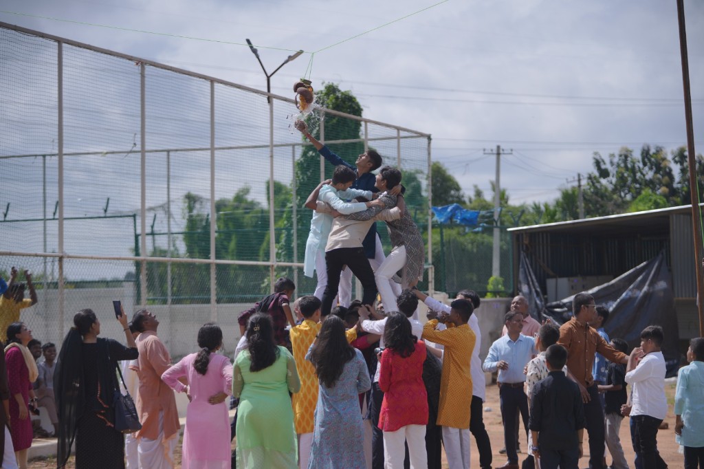 Students celebrating Dahi Handi on campus at TACS