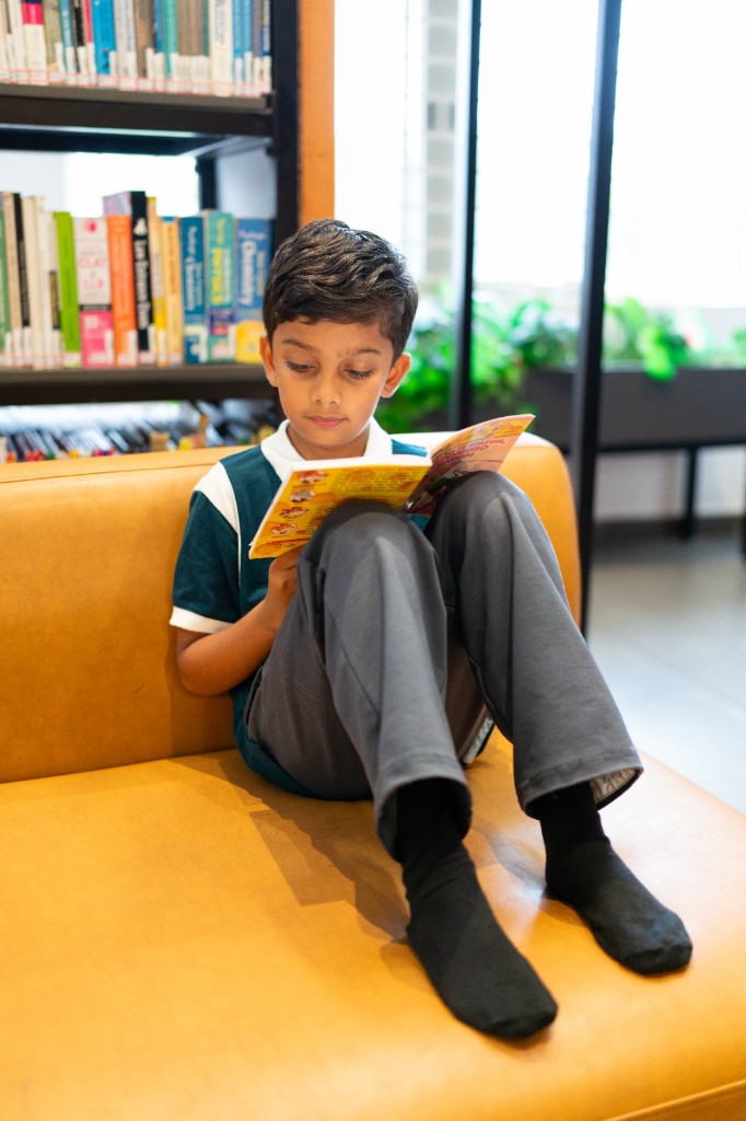 Student reading in the campus library at TACS
